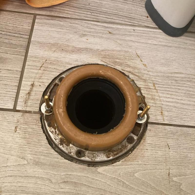 Toilet flange with new wax ring installed on floor Toilet flange with new wax ring installed on floor