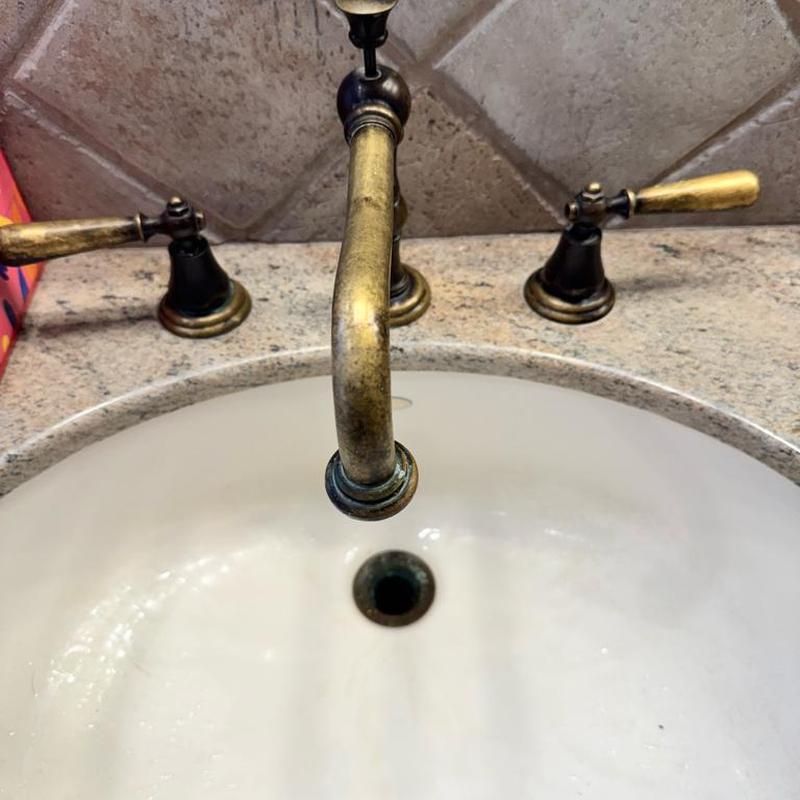 Bathroom faucet with aged brass handles and spout
