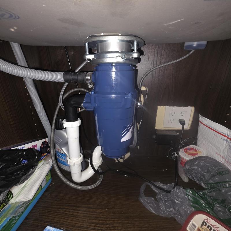 Garbage disposal unit installed under kitchen sink Garbage disposal unit installed under kitchen sink