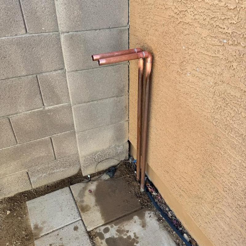Copper water softener pipes installed by wall