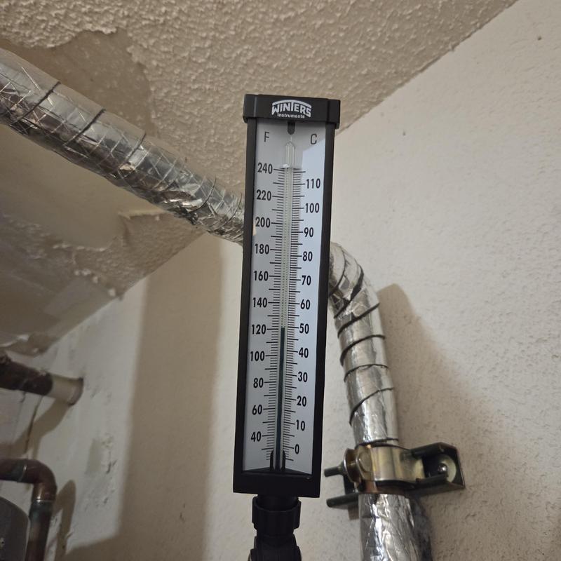 Thermometer gauge on insulated HVAC pipe system