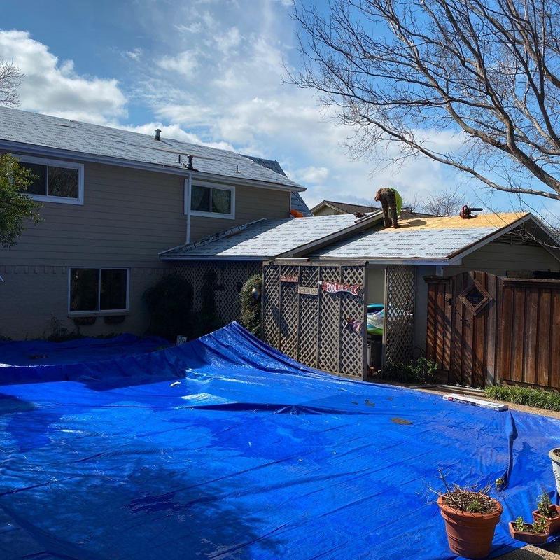 Hail damaged roof underlay installation with tarp cover