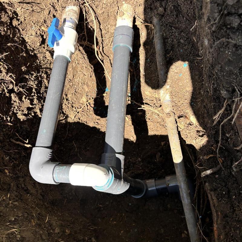 2-inch irrigation piping with new fittings in soil trench