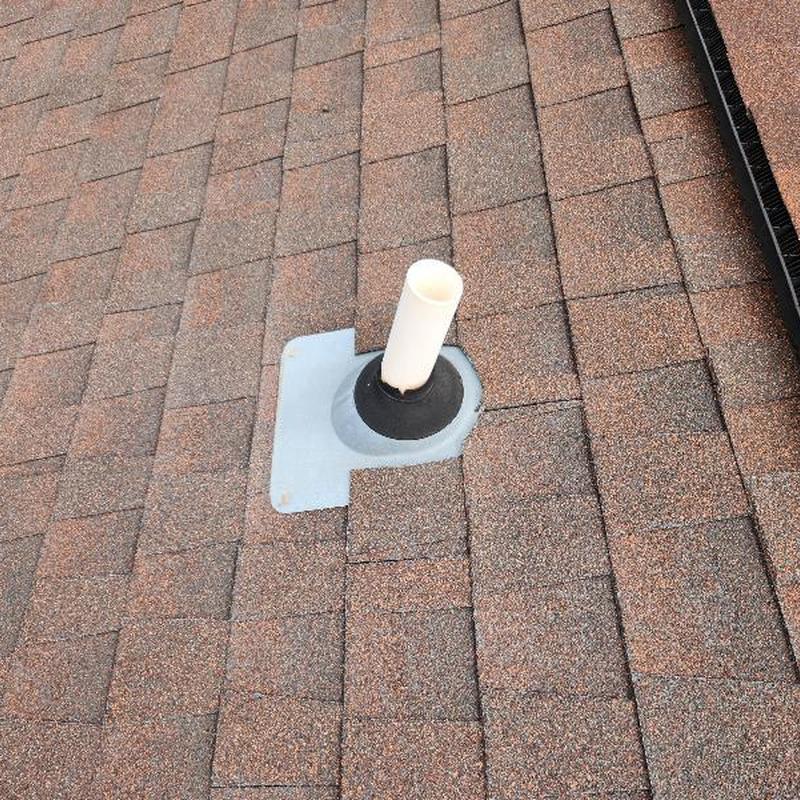 Roof plumbing vent boot with cracked seal on shingles Roof plumbing vent boot with cracked seal on shingles