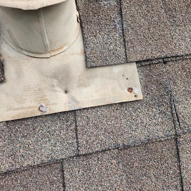 Asphalt shingle roof with worn and damaged flashing Asphalt shingle roof with worn and damaged flashing