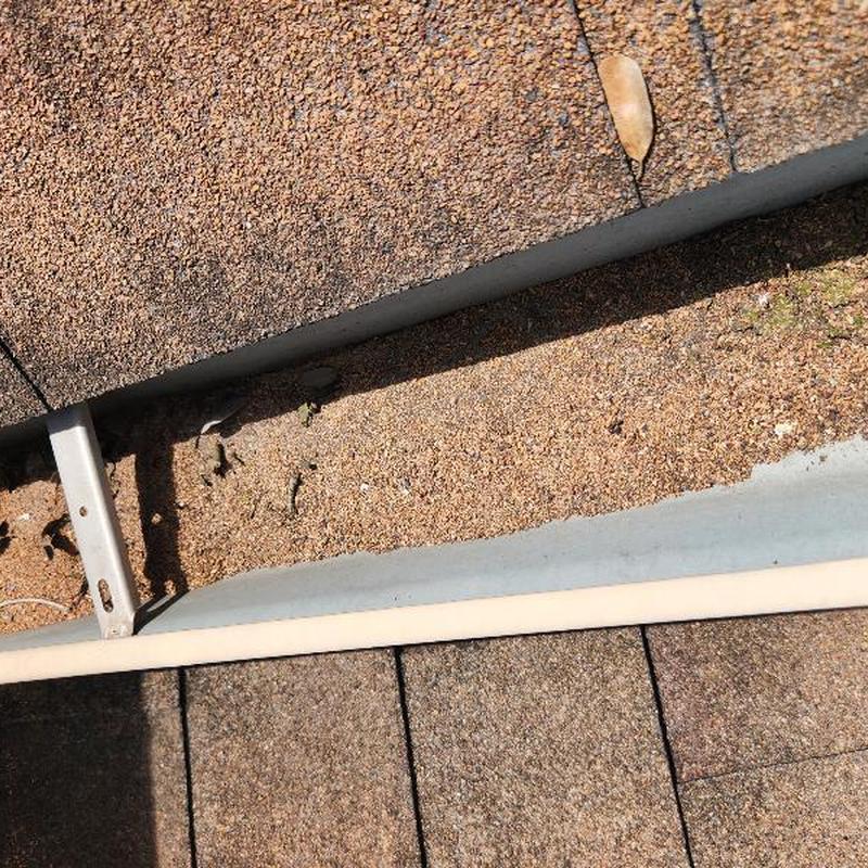 Asphalt roof shingles with cracks and granular loss Asphalt roof shingles with cracks and granular loss