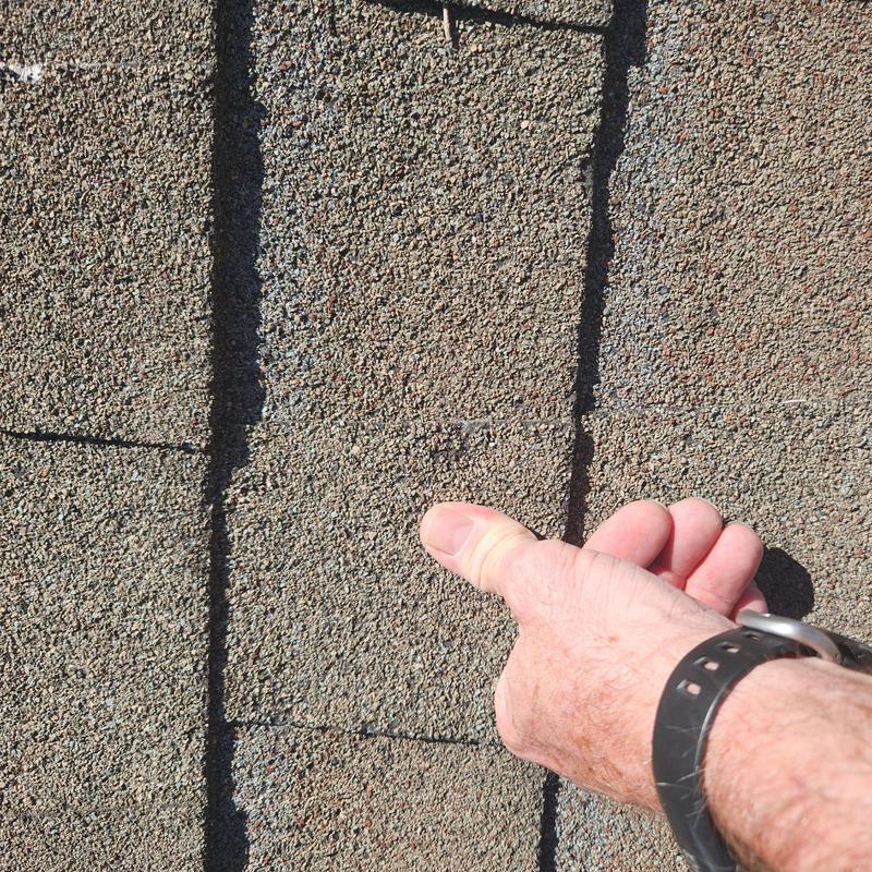 Asphalt shingles granular loss and damage close-up Asphalt shingles granular loss and damage close-up