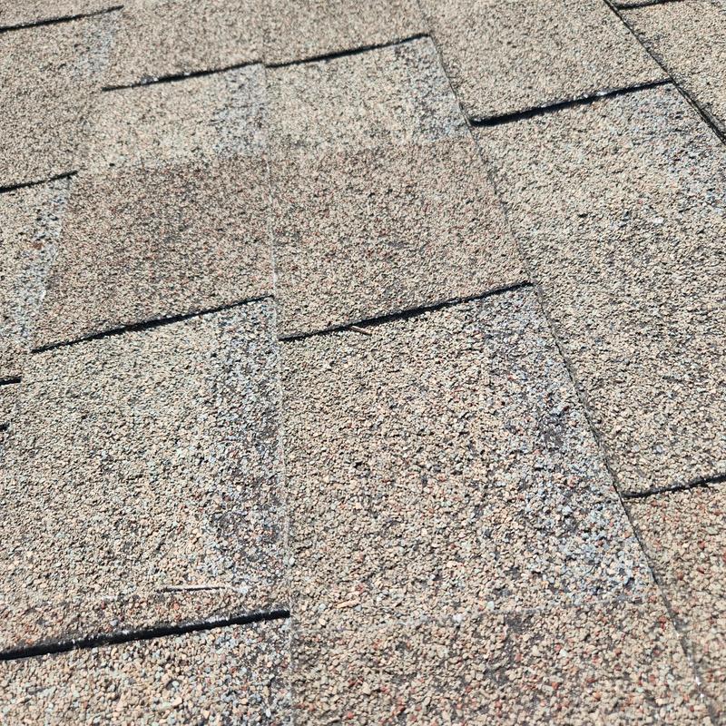 Asphalt shingles with granular loss and hail damage Asphalt shingles with granular loss and hail damage