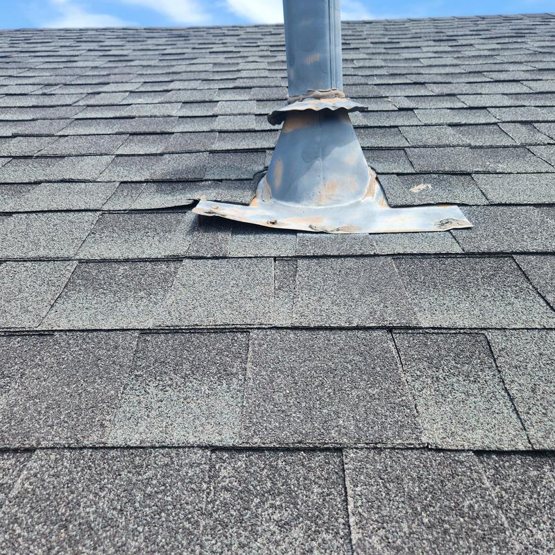 Flashing on roof with lifting and missing shingles