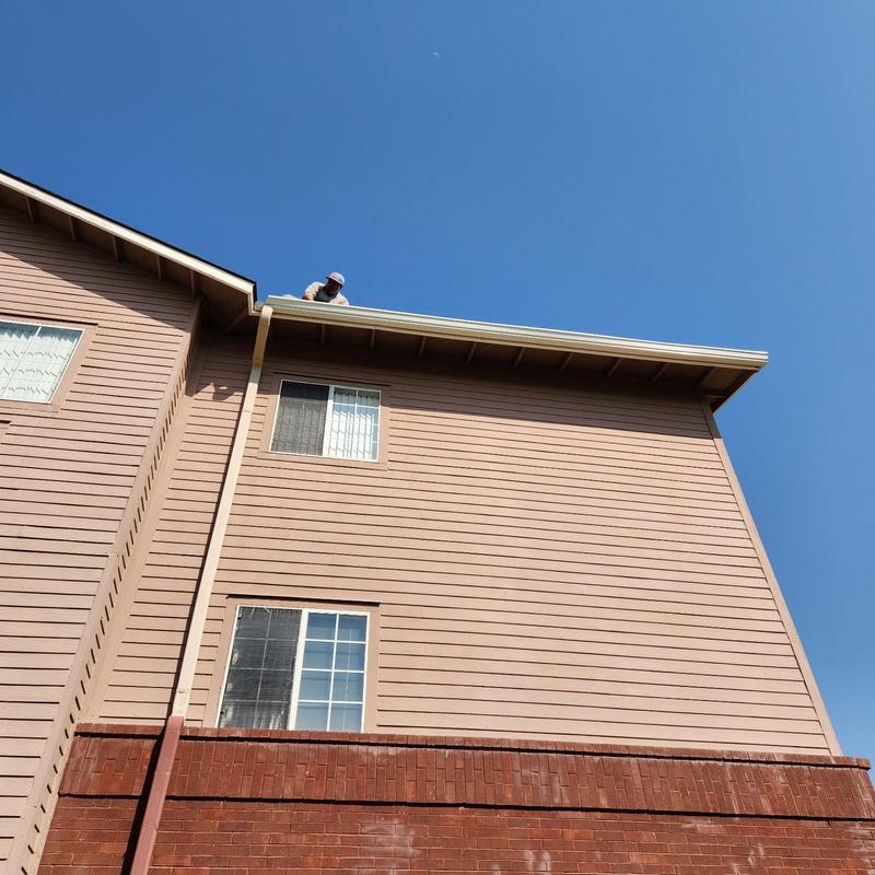 Gutter and downspout on three-story commercial building