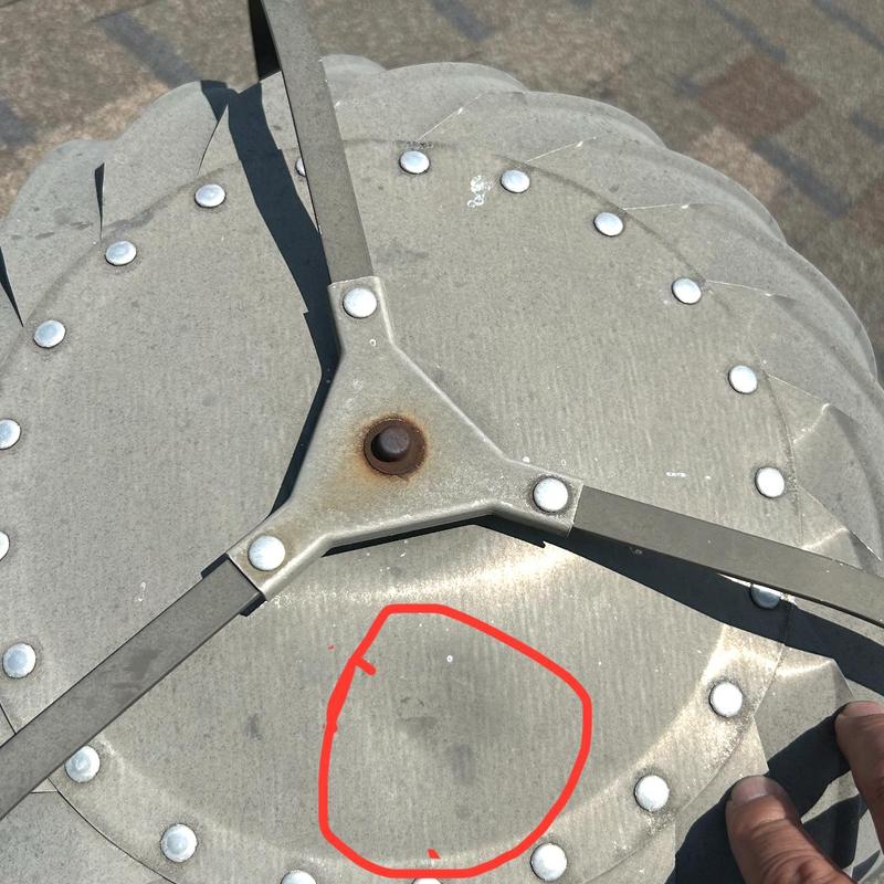 Metal roof turbine vent with rust spot marked in red