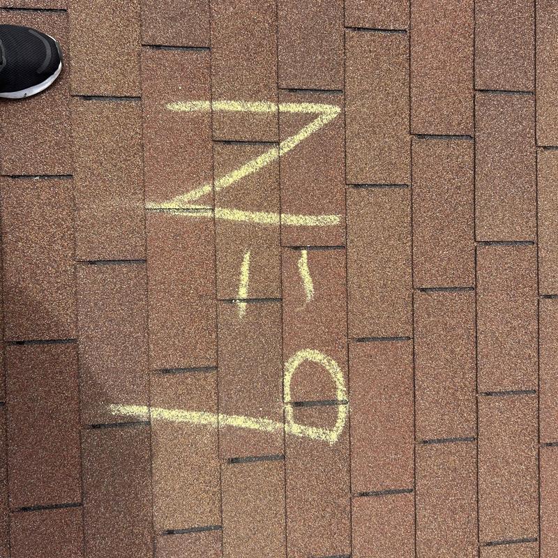 Roof shingles with chalk markings during inspection