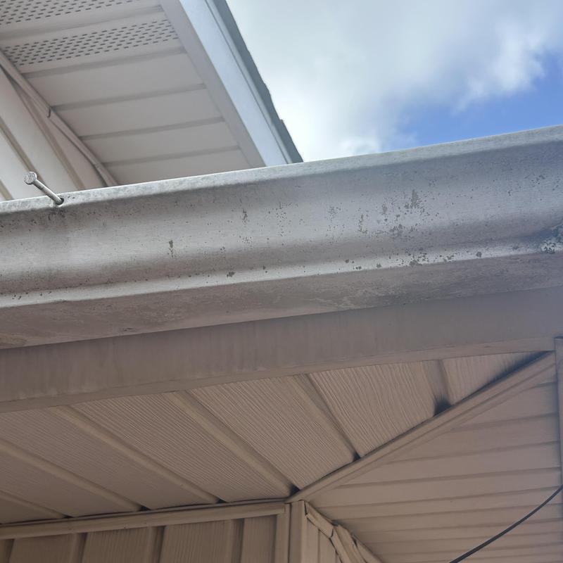 Metal gutter and vinyl soffit siding intersection detail