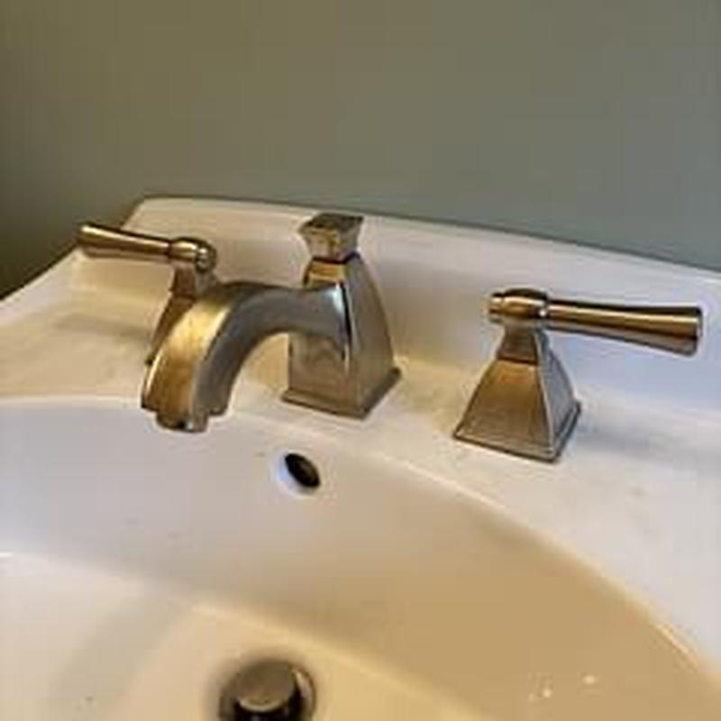 Wide set bathroom faucet with metal handles