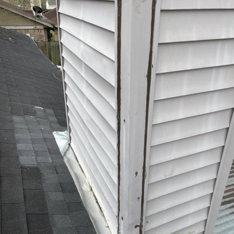 Siding wall roof flashing with new shingles and underlayment