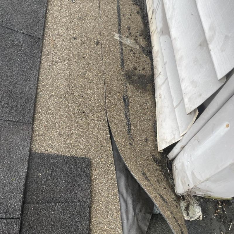 Step flashing near siding wall with lifted underlayment