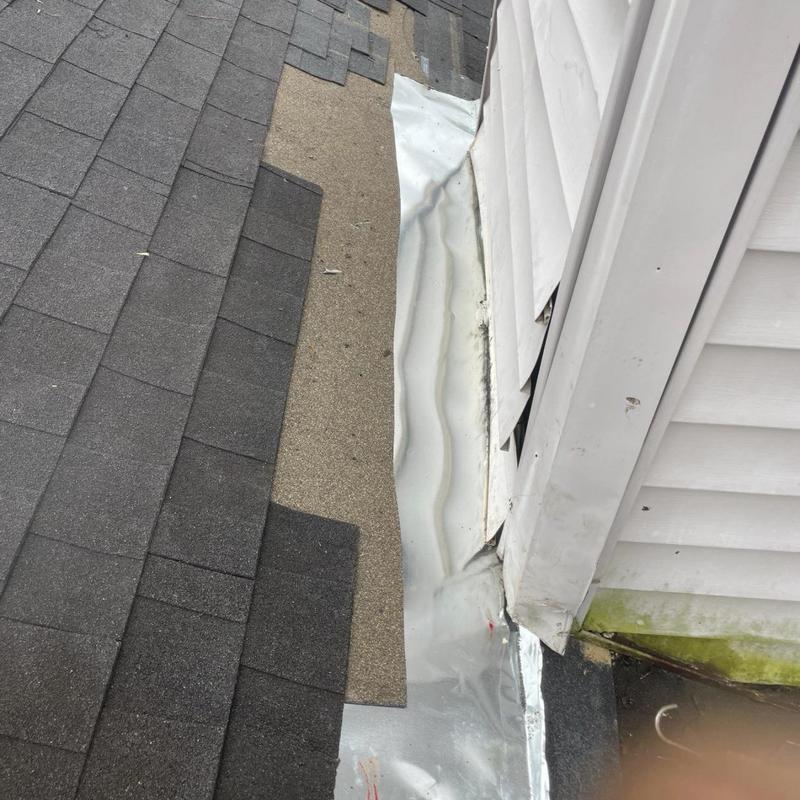 Roof flashing and shingle replacement near siding wall