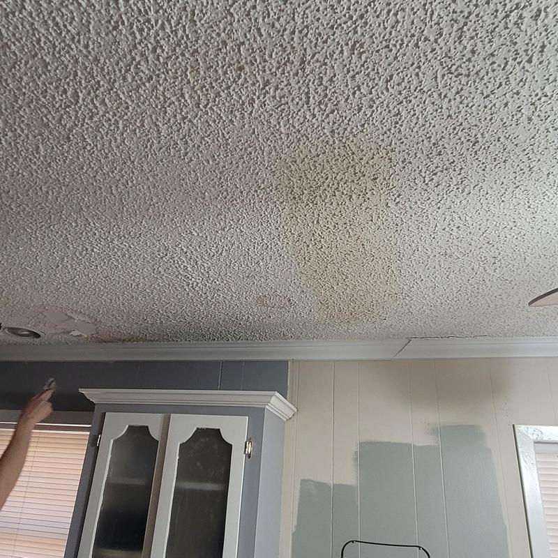 Popcorn ceiling with water stains and damage
