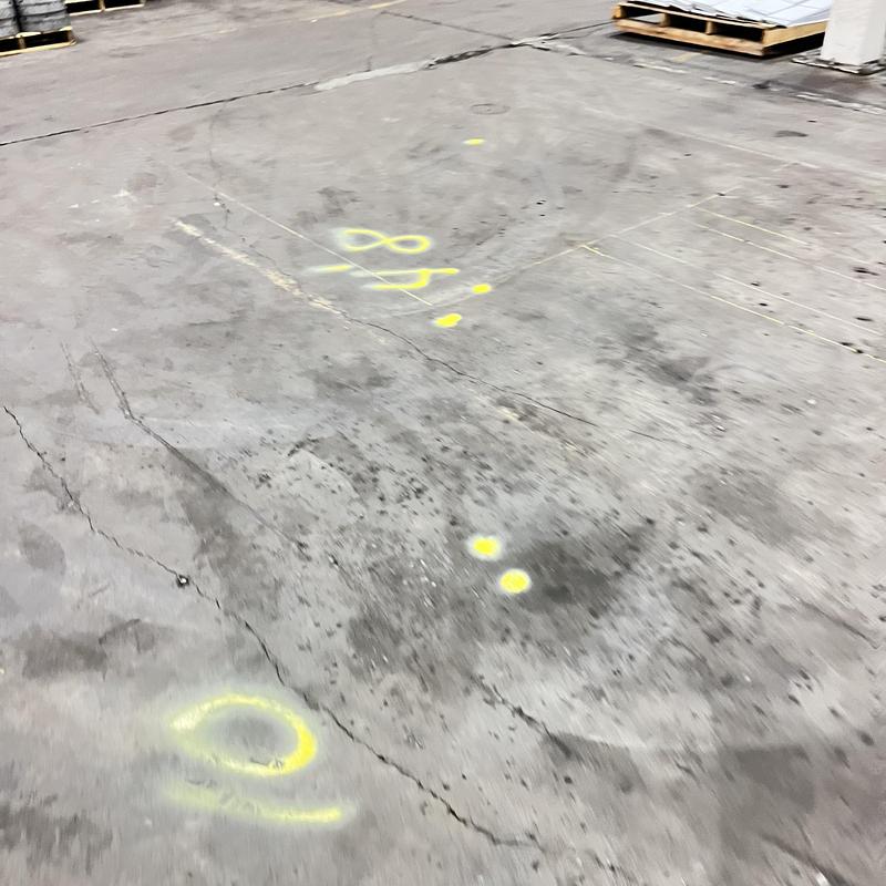 Sewer line location markings on concrete floor