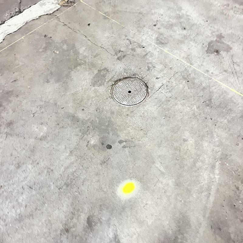 Sewer line access cover with marked concrete floor