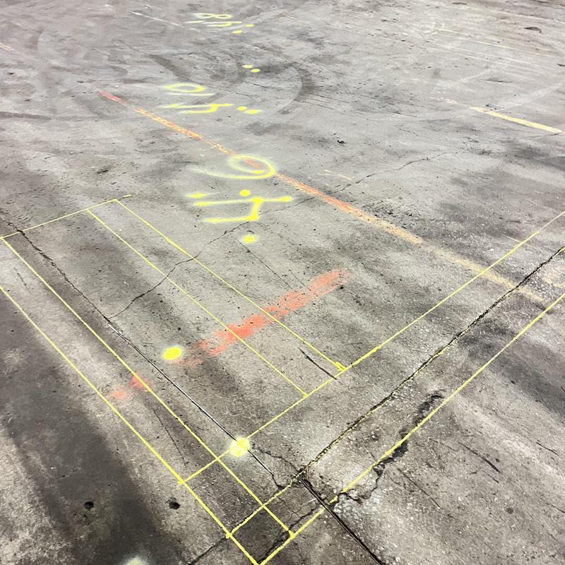 Sewer line location markings on concrete floor