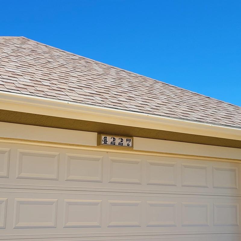 Shingle roof and gutter above garage door