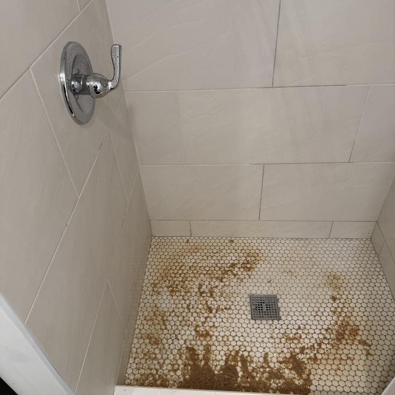 Shower floor tile with rust and dirt stains Shower floor tile with rust and dirt stains
