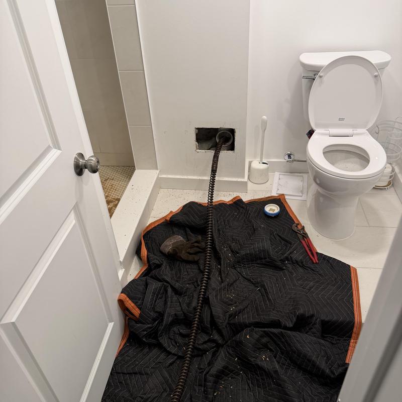 Main line drain cleaning with snake in bathroom Main line drain cleaning with snake in bathroom