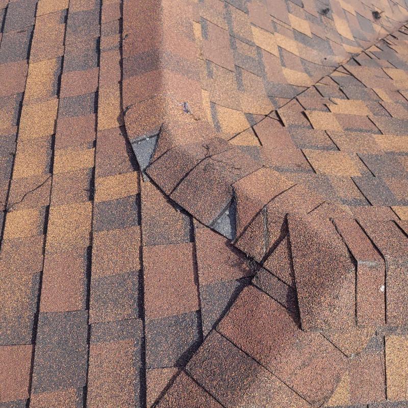 Shingle roof hip cap with failing repairs in Cape Coral