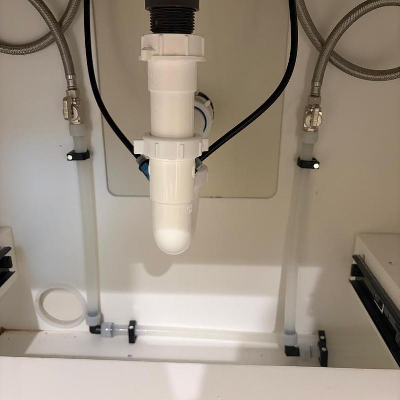 Lavatory faucet drain and water supply connections under sink