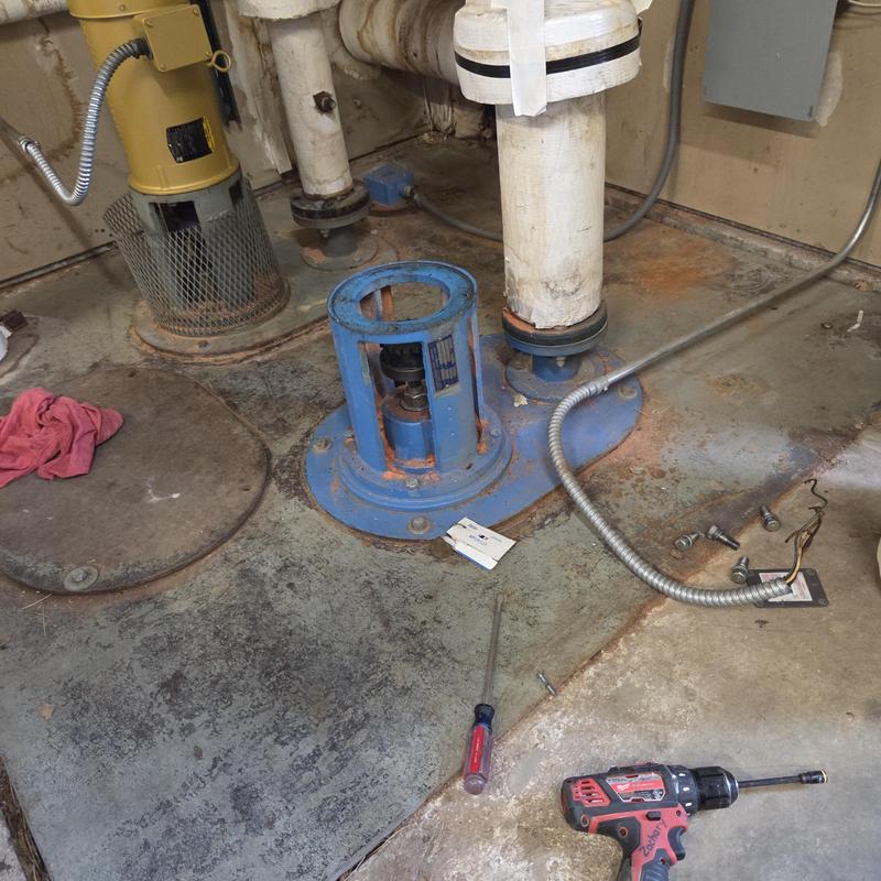 Cooling tower pump motor housing with tools nearby