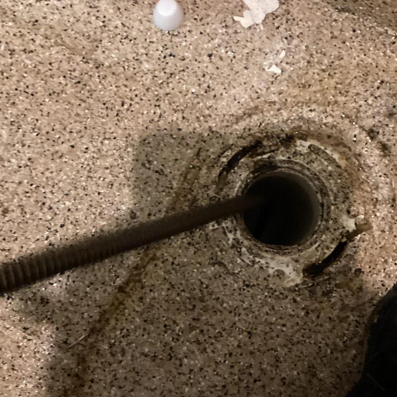 Main sewer line with auger clearing blockage