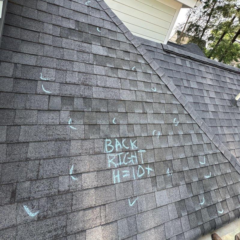 Architectural shingles on roof with hail damage marks