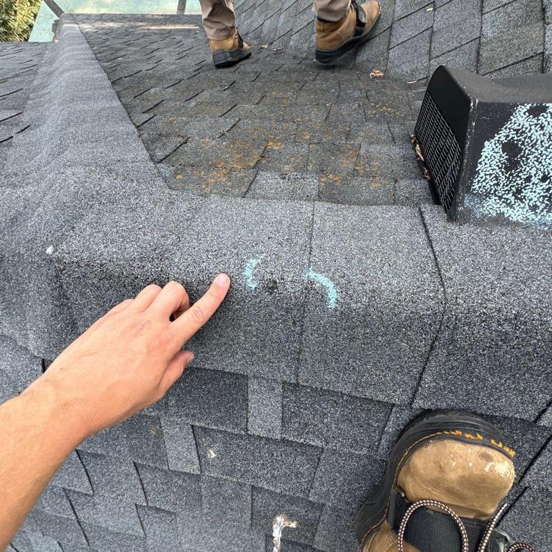 Roof shingles with hail damage and chalk markings