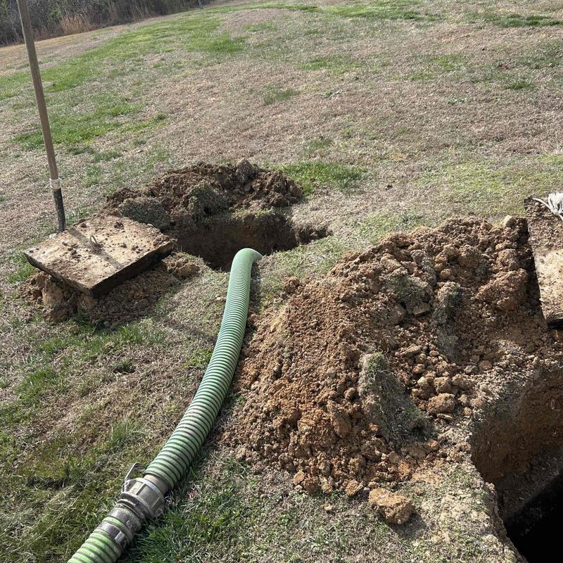 Septic tank pumping with hose and soil mounds