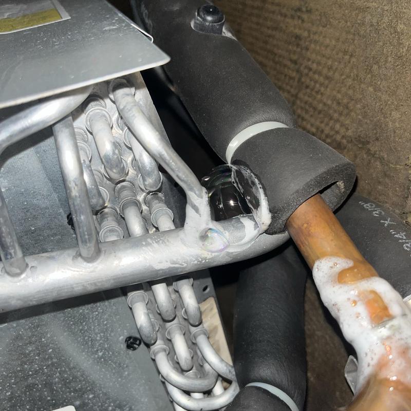 AC evaporator coil and refrigerant line with leak sealant foam