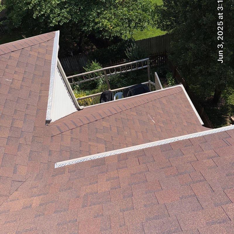 Asphalt shingle roof with ridge cap and flashing installation