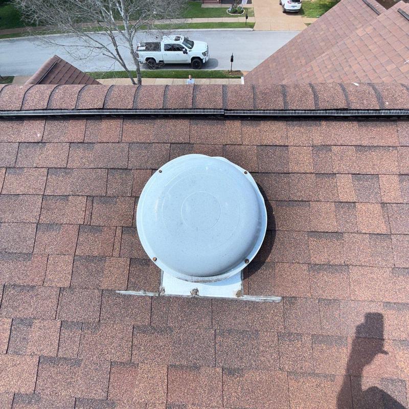Roof vent and surrounding shingles with minor damage