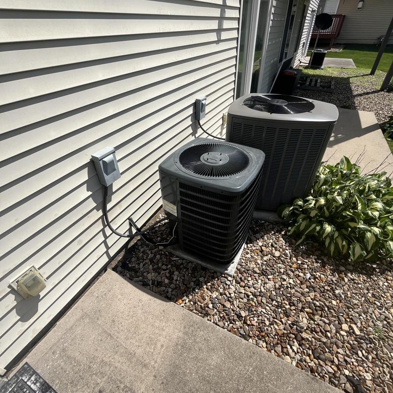 Goodman AC compressor unit outside house