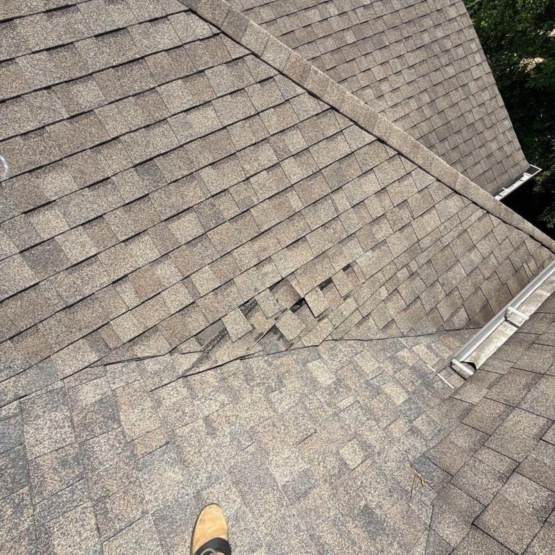 Roof shingles with visible hail damage and missing pieces
