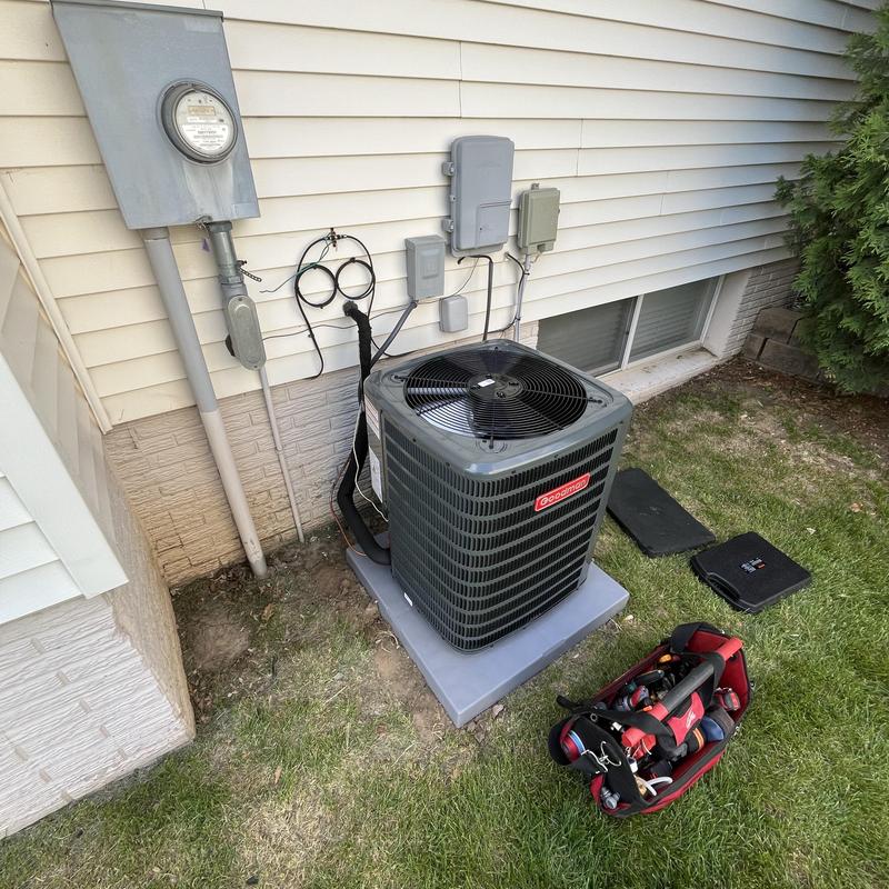 Goodman AC unit installation on house exterior