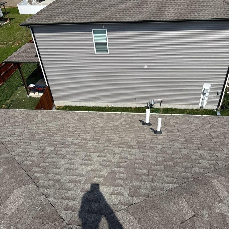 Architectural shingle roof with vent pipes in residential area