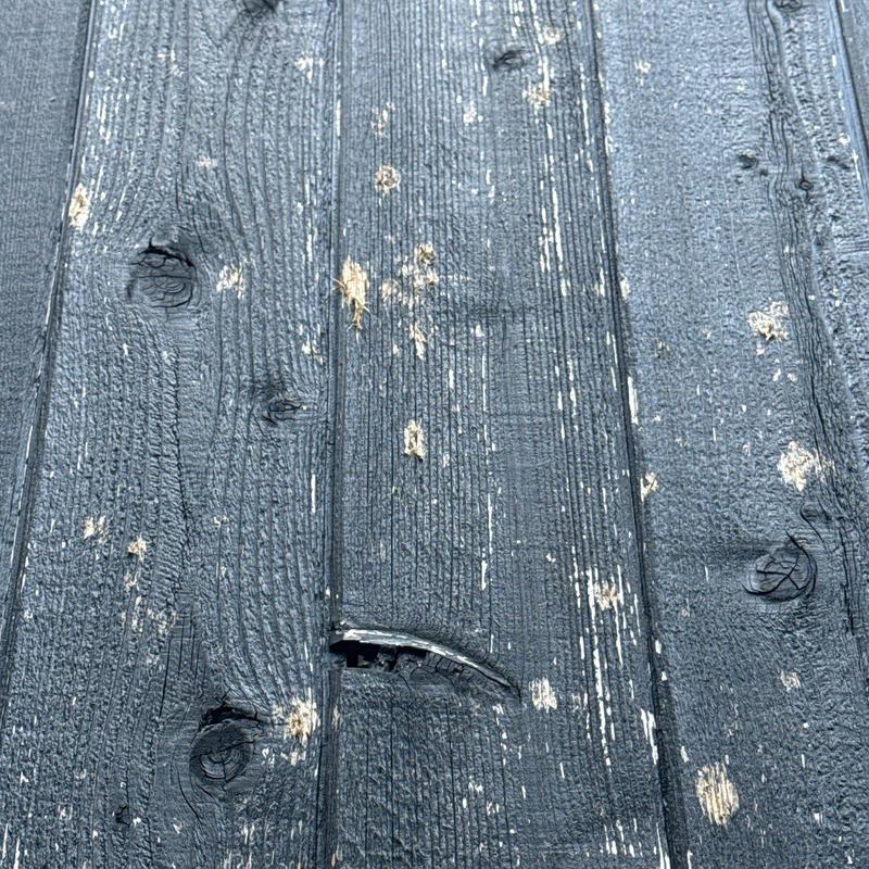 Wooden roof deck showing hail damage and cracks