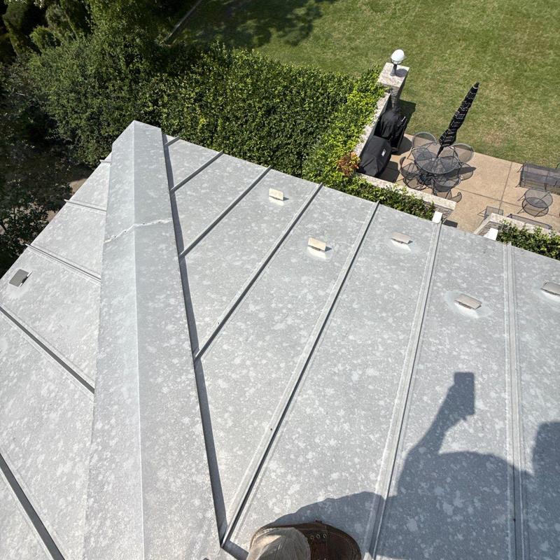 Standing seam metal roof with hail damage spots