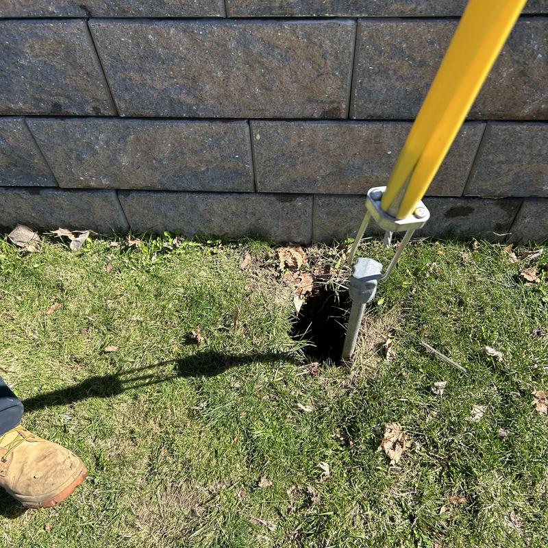 Sewer cleanout access with jetting tool in grass Sewer cleanout access with jetting tool in grass