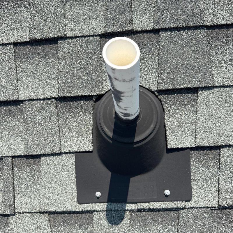 PVC vent pipe with new roof flashing on shingles