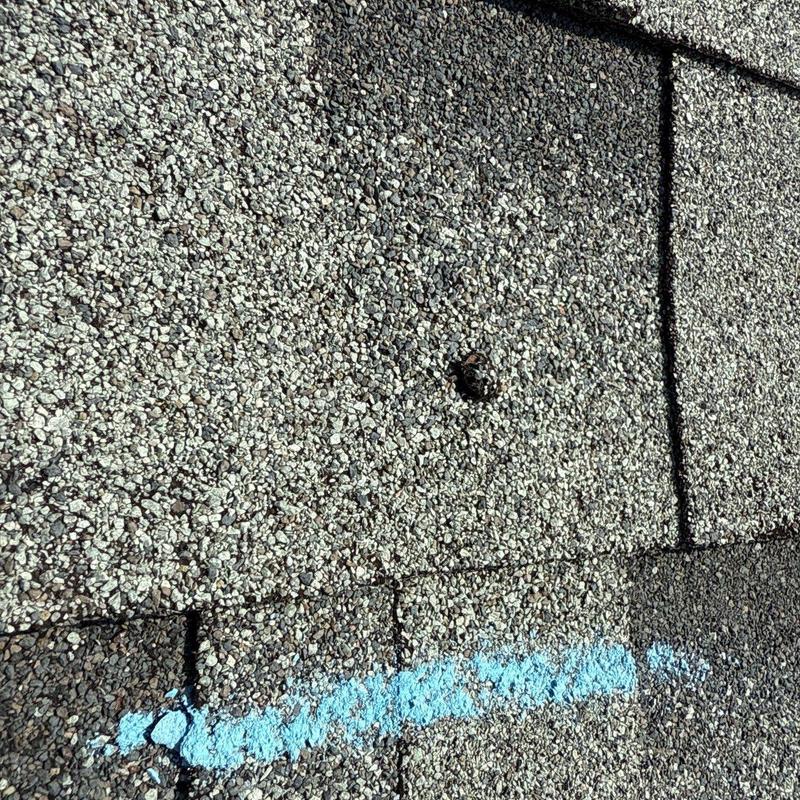 Architectural asphalt shingles with hail damage mark