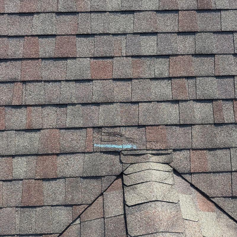 Asphalt shingles with hail impact damage and chalk marks