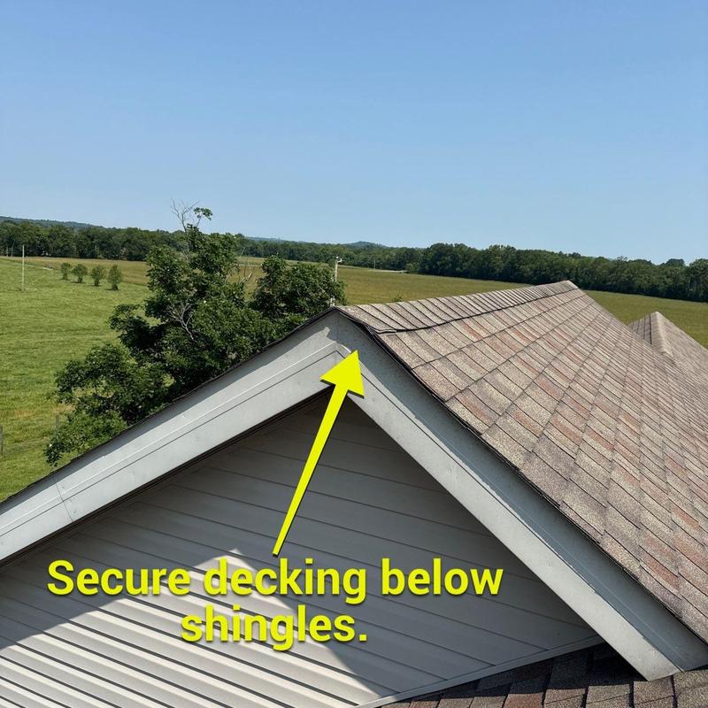 Roof decking below shingles with securing note