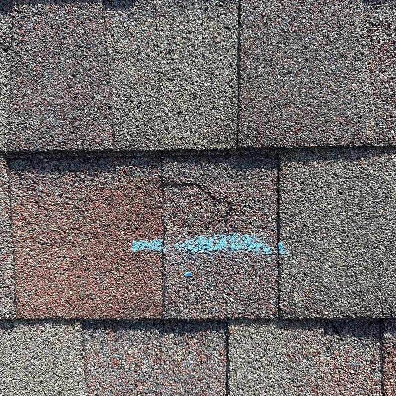 Asphalt shingles with hail impact and blue marking